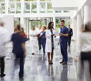 Busy hospital lobby with doctor and patient