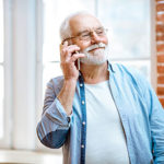 Old man on phone indoors