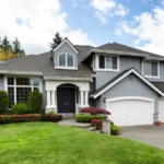 Two level blue house with white trim.