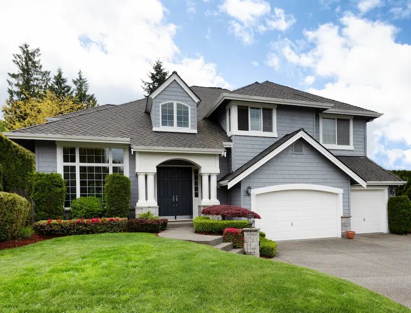 Two level blue house with white trim.