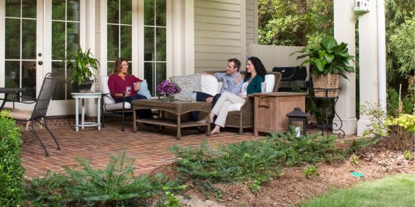 People gathered on a backyard outdoor patio