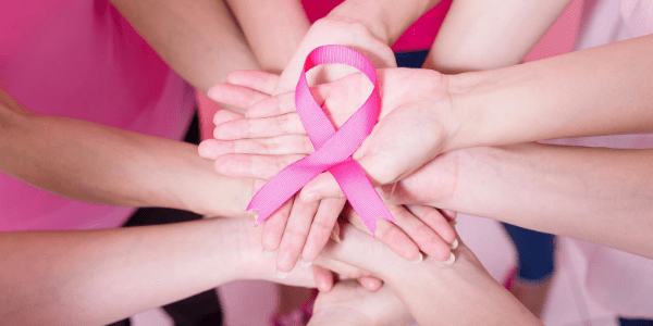 Hands Holding Pink Breast Cancer Ribbon