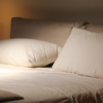 empty bed at night with lamp on