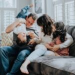 Family gathered together on a couch