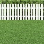 Green grass with white picket fence