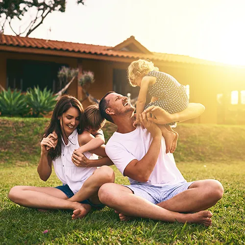 Family outside their home - Keep pests away from your home with Suburban Exterminating in NY