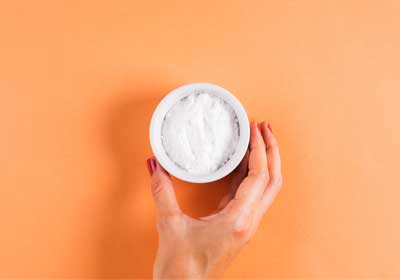 Hand holding bowl of baking soda