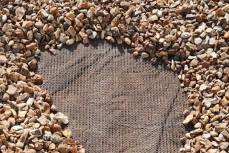 Flexi Armour ground mesh being used by Suburban Exterminating to seal the gap space between holes in the ground.