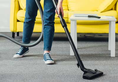 Person steam cleaning carpet