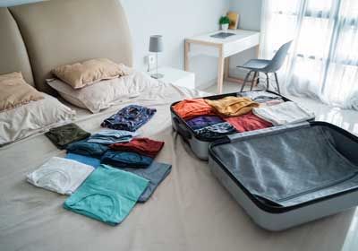 Partially packed luggage on bed